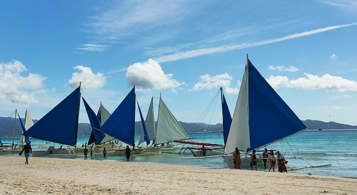 Paraw boats in Boracay Island white sand beach